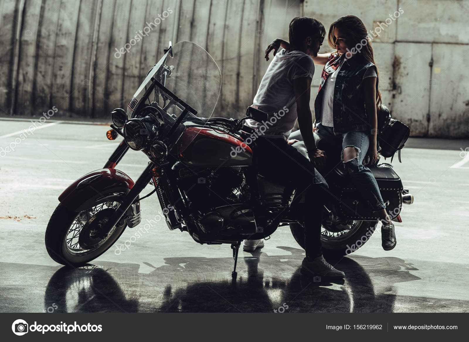 Young couple with motorcycle — Stock Photo © ArturVerkhovetskiy