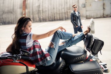 Young couple with motorcycle  clipart