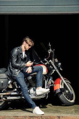 Stylish man with motorbike  clipart