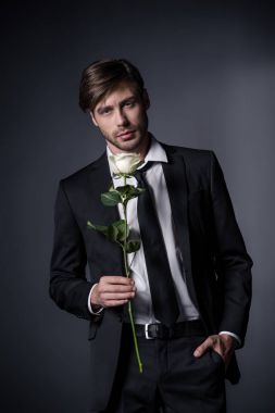 man in suit holding white rose clipart