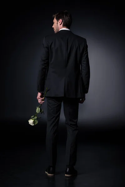 Man in formal wear holding rose — Stock Photo, Image