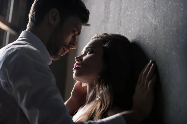 Passionate couple able to kiss near wall — Stock Photo, Image