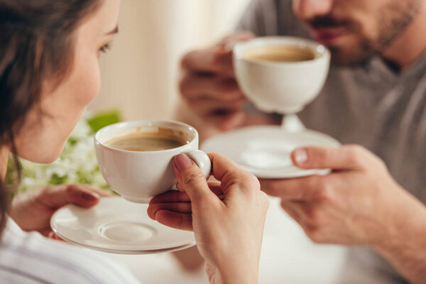 young couple drinking coffee at home