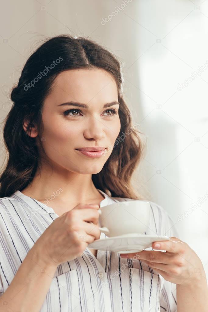 young caucasian woman drinking coffee