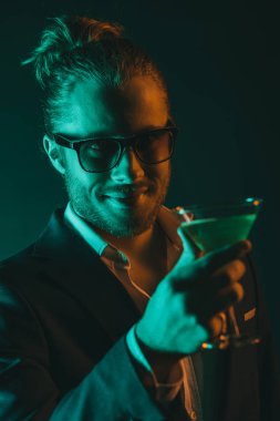 stylish man holding glass with cocktail clipart