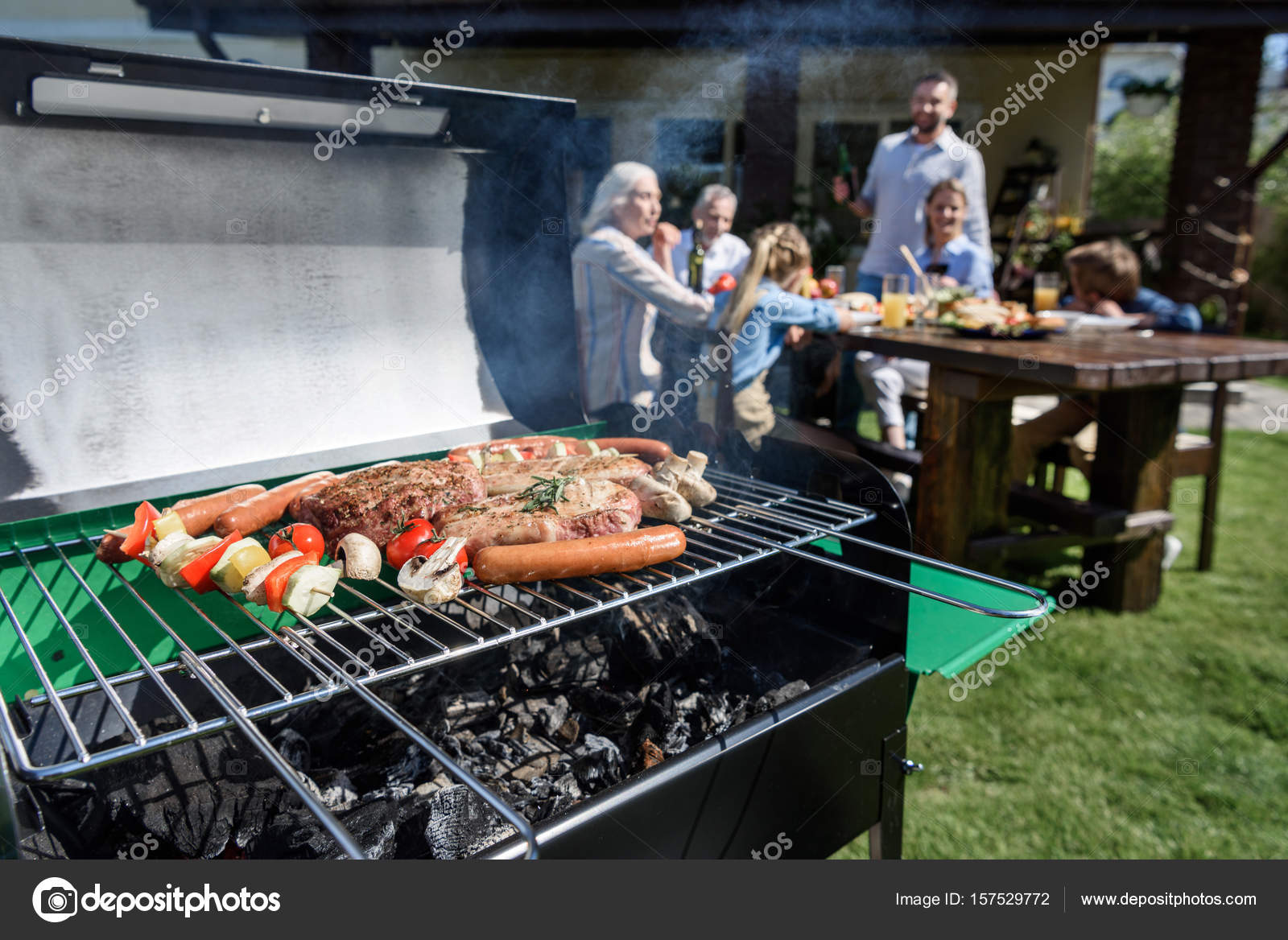 Meat and vegetables cooking on grill Stock Photo by ©ArturVerkhovetskiy