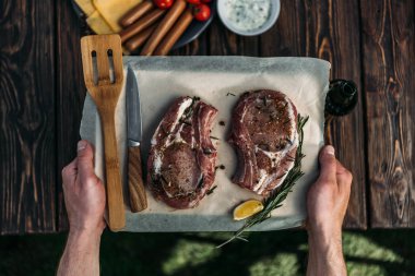 raw ribeye steaks with spices clipart