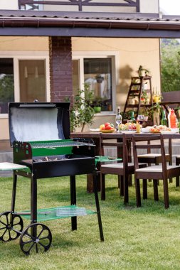 Grill on green lawn  clipart