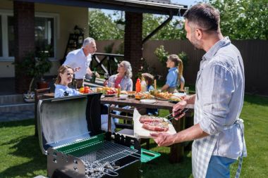 Happy family at barbecue  clipart