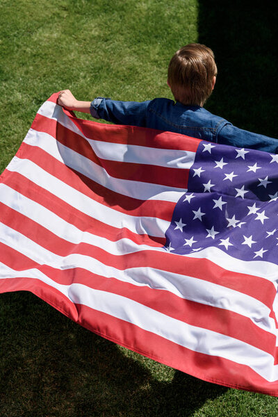 boy running with american flag