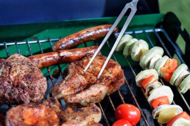 meat pricked by carving fork on grill clipart