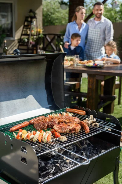 Meat and vegetables cooking on grill — Stock Photo, Image