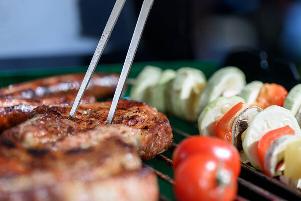 meat pricked by carving fork on grill