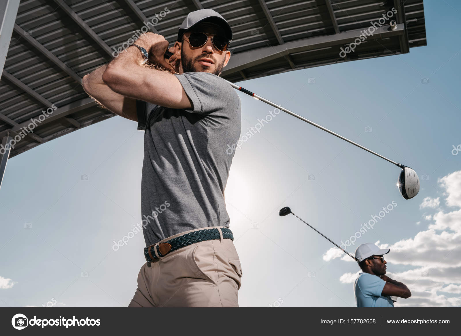 Men playing golf — Stock Photo © ArturVerkhovetskiy 157782608