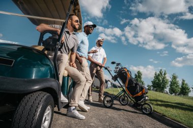 men standing near golf cart clipart