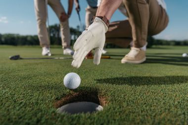 golf oyuncu topu almaya çalışırken