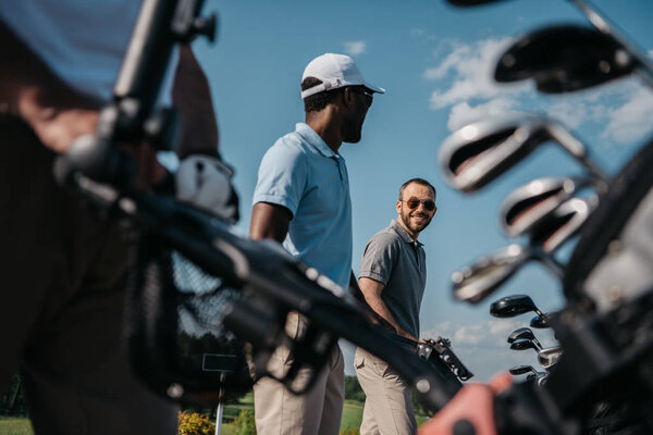 smiling players going to golf course