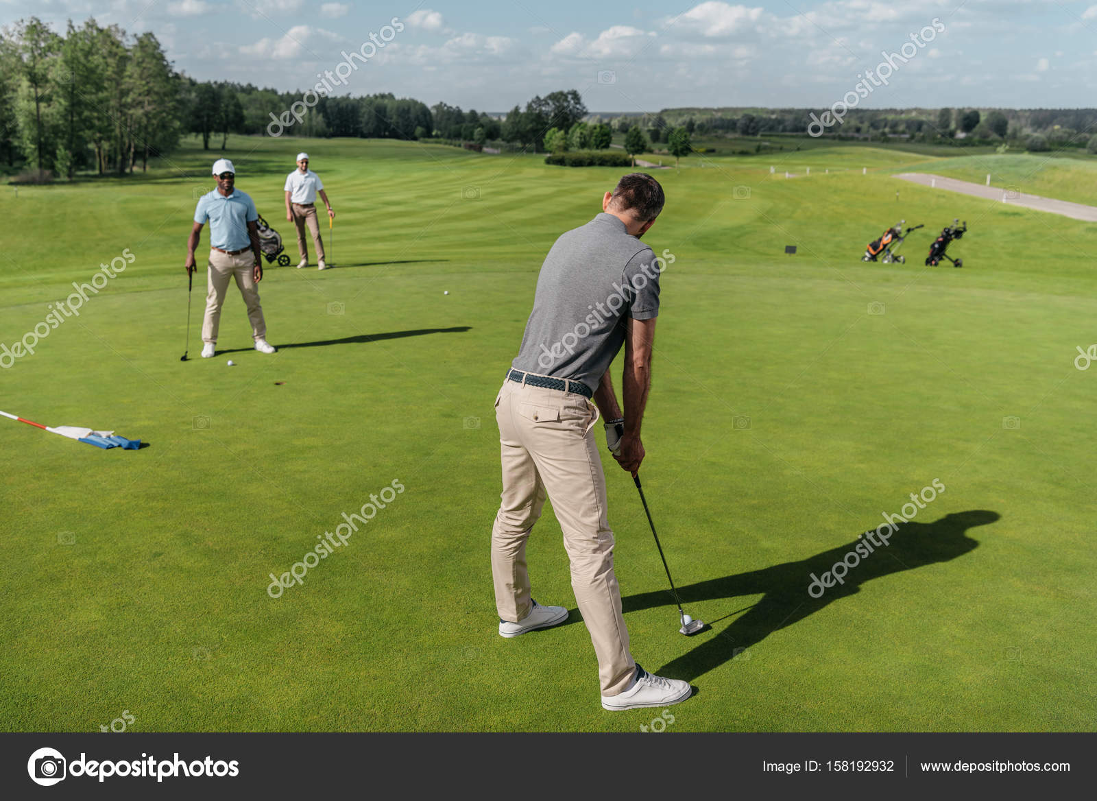 Casual men playing golf Stock Photo by ©ArturVerkhovetskiy 158192932