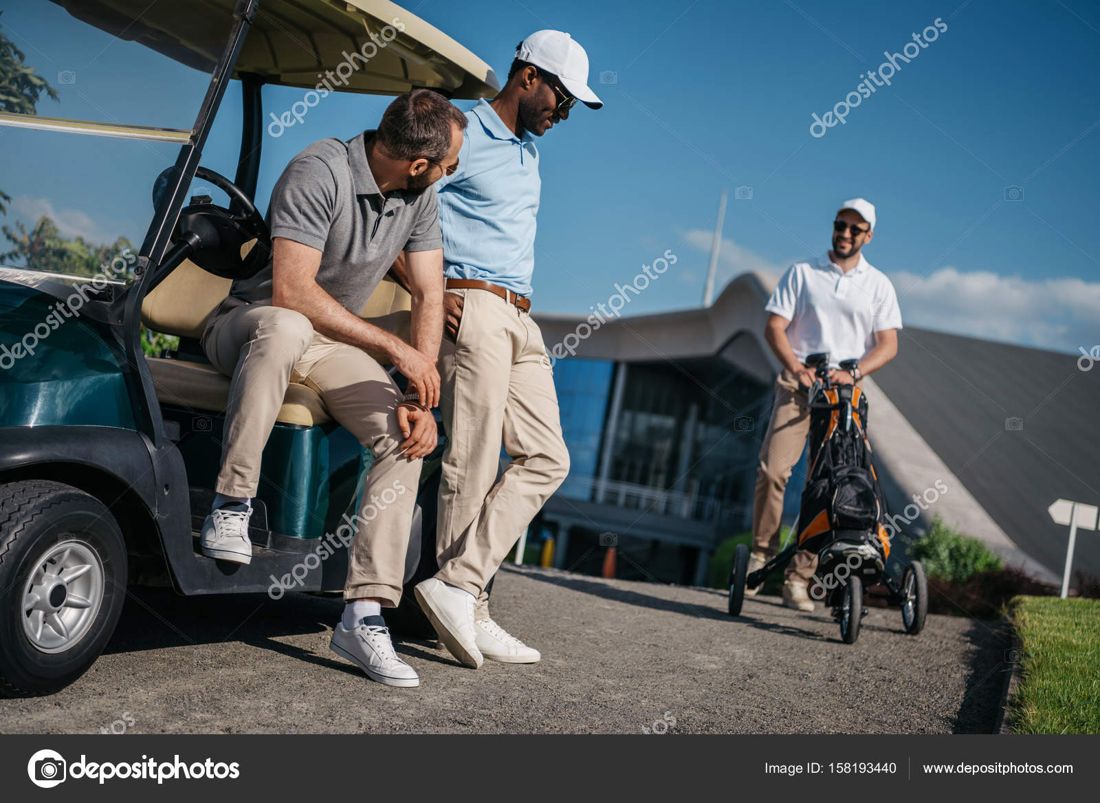 Men standing near golf cart — Free Stock Photo © ArturVerkhovetskiy
