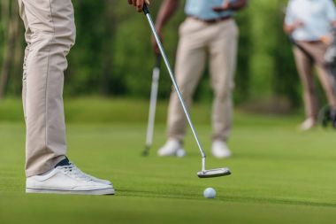 golfer getting ready to shot on fairway clipart