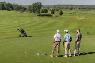 professional players standing on golf pitch clipart