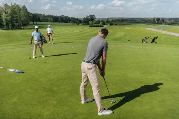 Casual men playing golf — Stock Photo, Image