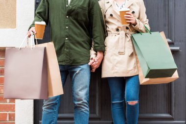 couple with shopping bags on street clipart