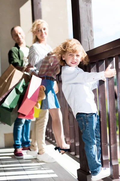 Little blond boy standing on balcony — Free Stock Photo