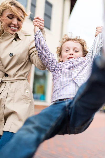 Mother with son having fun on street — Free Stock Photo