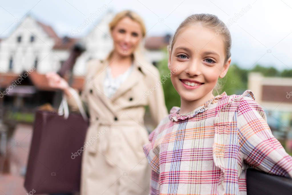 girl with mother with shopping bags