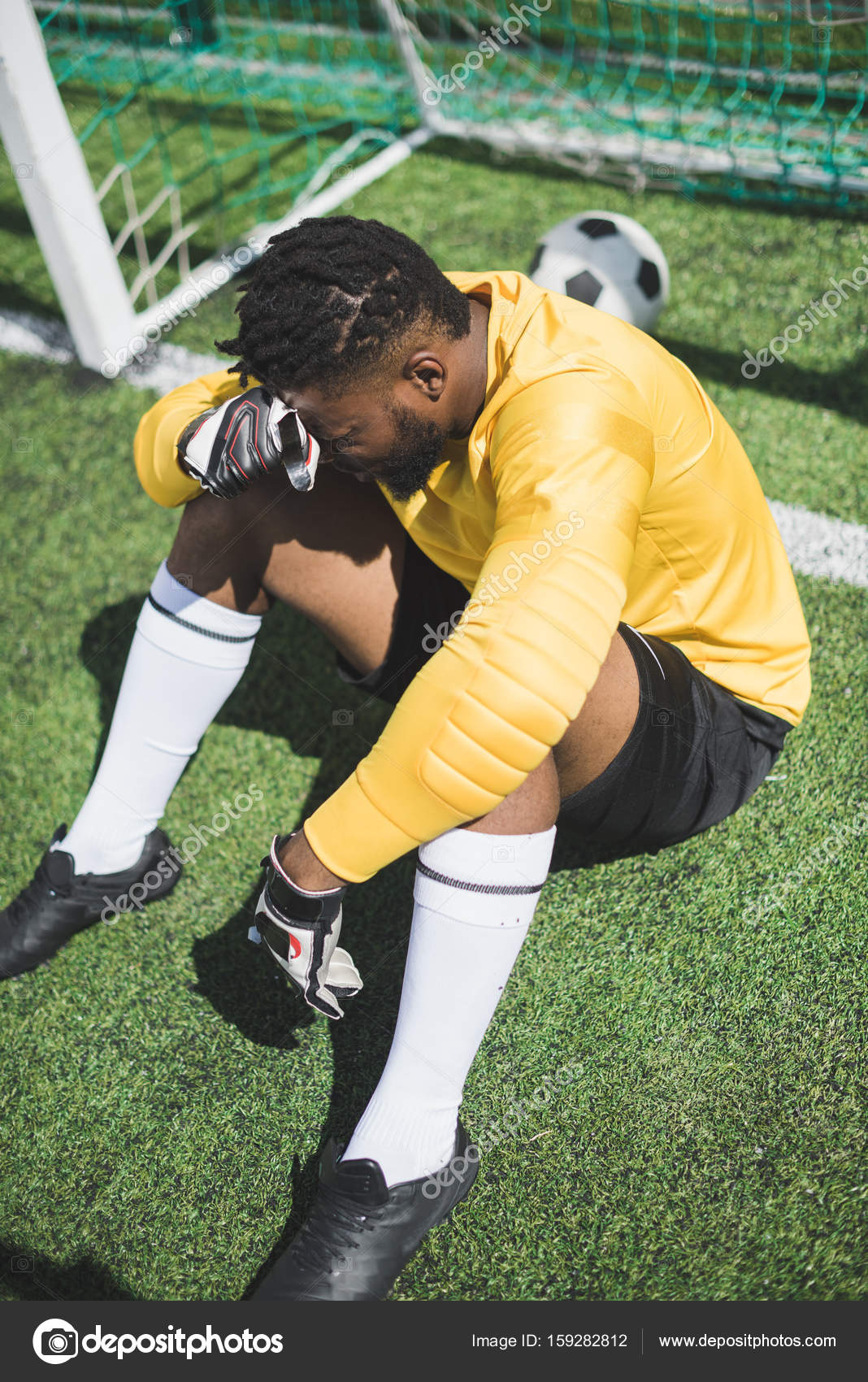 African american goalkeeper at pitch — Stock Photo © ArturVerkhovetskiy