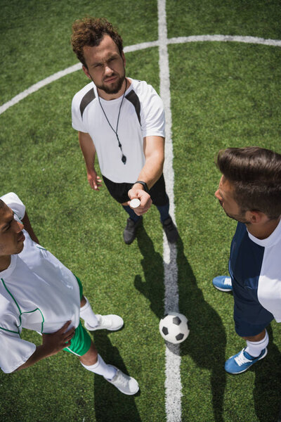 referee and soccer players