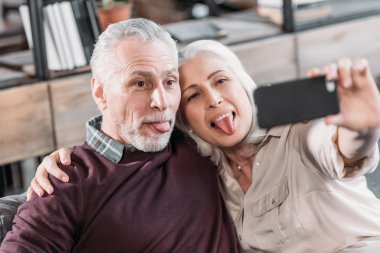 senior couple taking selfie clipart