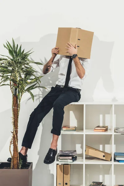 Businessman hiding face with folder — Free Stock Photo