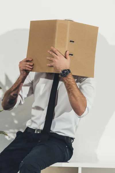 Businessman hiding face with folder — Free Stock Photo