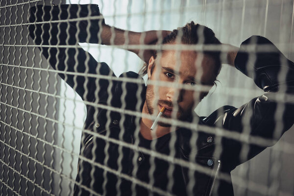 Stylish long haired man with cigarette