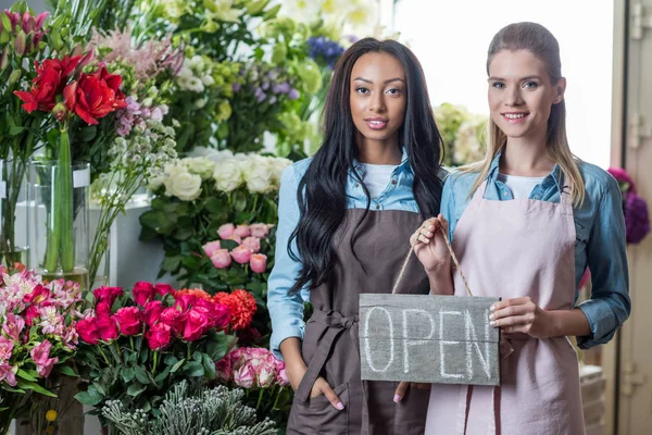 Multiethnic florists with open sign — Stock Photo, Image