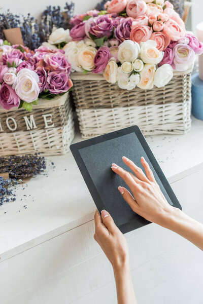 florist using digital tablet