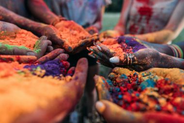 colorful holi powder in hands clipart