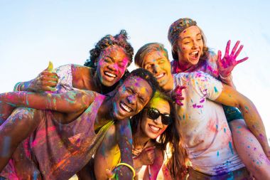 happy friends at holi festival clipart