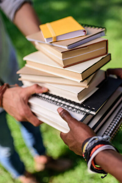 students holding books