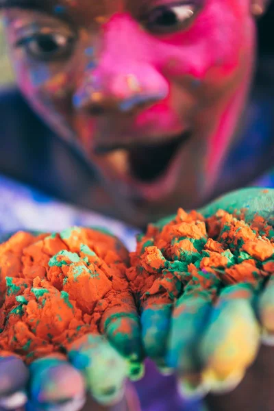 Woman blowing colorful powder — Stock Photo, Image