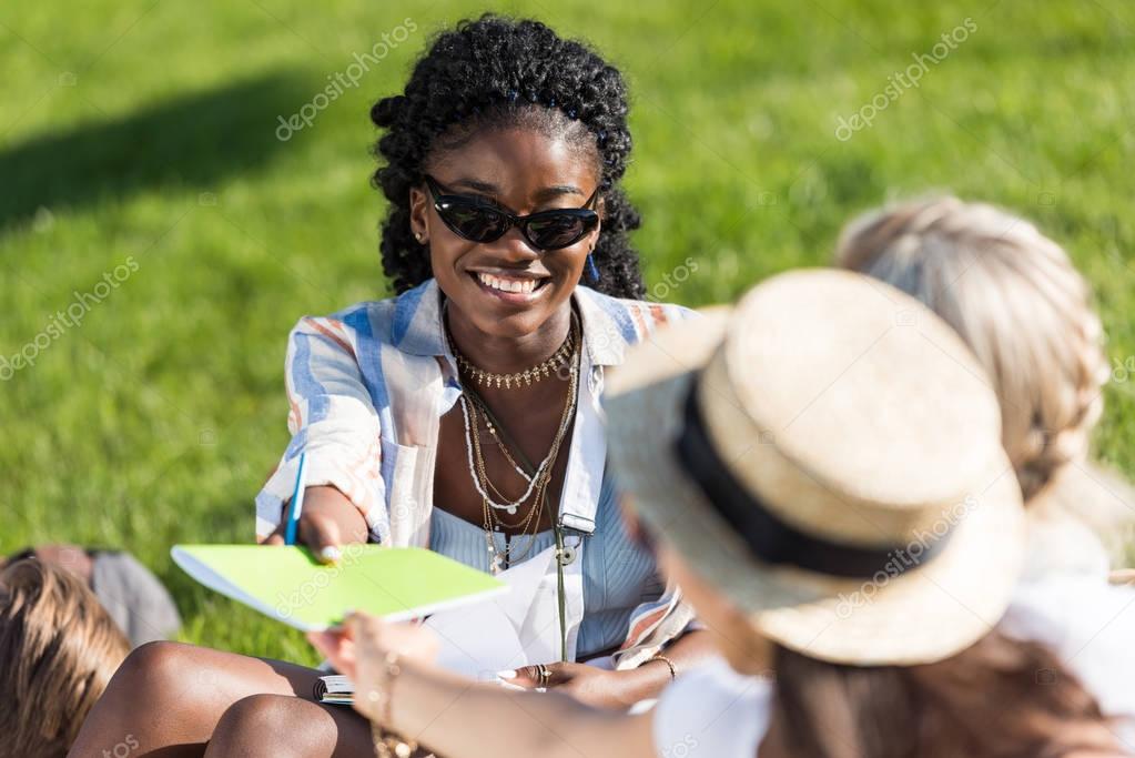 multiethnic students studying in park