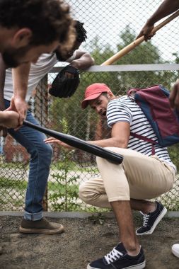 men attacking other one with baseball bats clipart