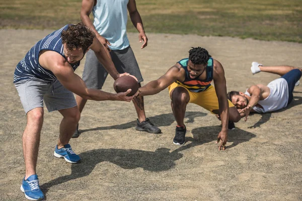 Multicultural men playing football — Free Stock Photo