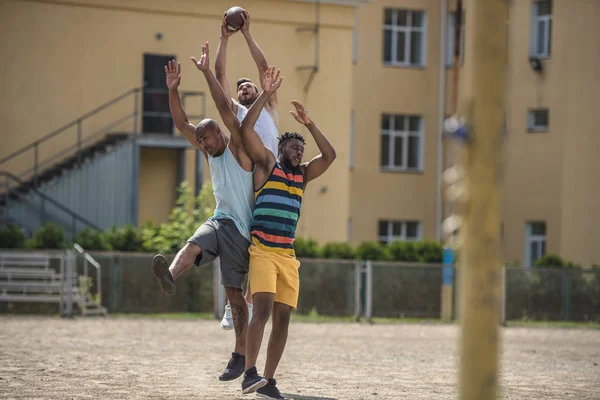 Мультикультурные мужчины играют в футбол — стоковое фото