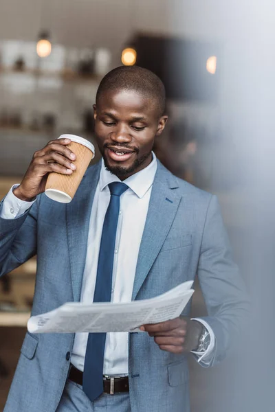 Businessman with coffee reading newspaper — Stock Photo, Image