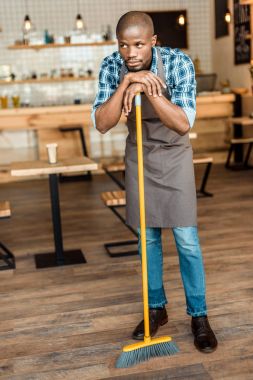 man brooming in coffee shop clipart