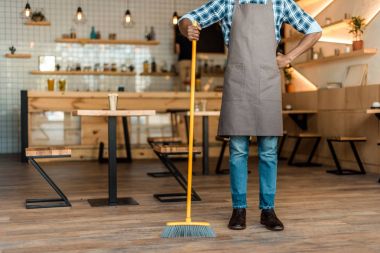 man brooming in coffee shop clipart