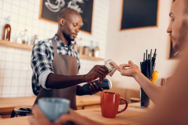 barista taking cash payment  clipart